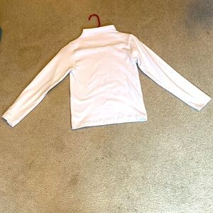 A white long sleeve turtleneck great for winter. Nice and cozy with hot cocoa